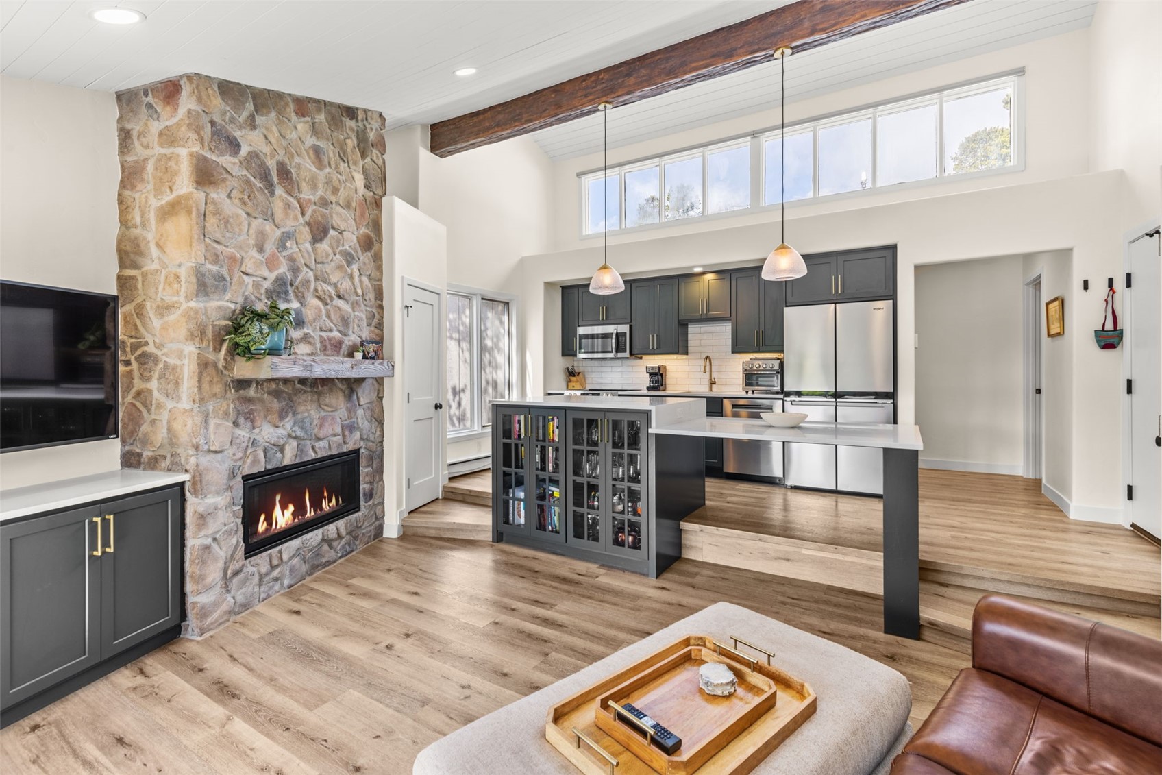 1127 Ski Hill Road, Unit 104 Breckenridge, CO 80424 - Photo 7 of 32 a living room with stainless steel appliances furniture fireplace and flat screen tv