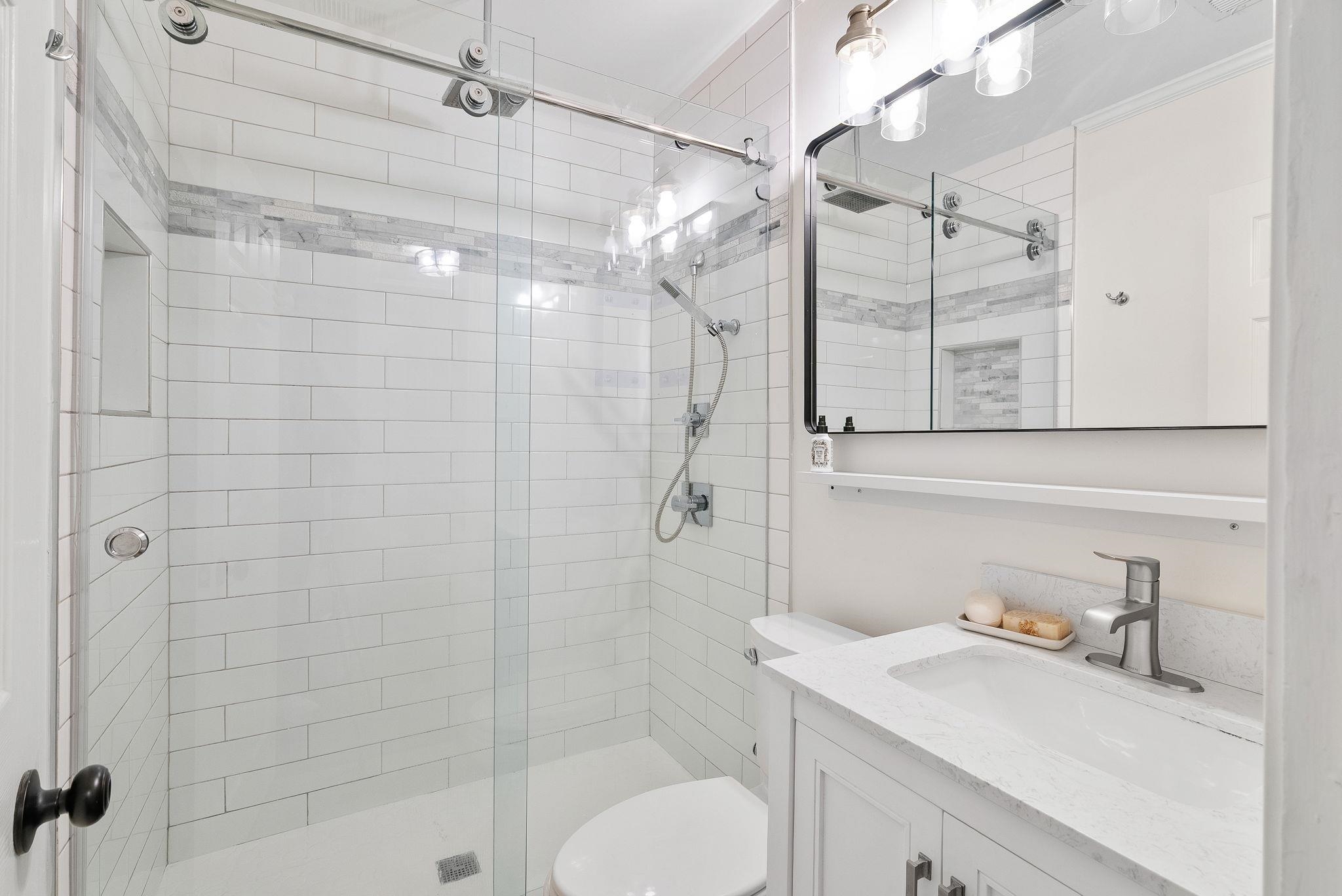 4780 Amboy Road Memphis, TN 38117 - Photo 24 of 32 a bathroom with a sink toilet a mirror and shower