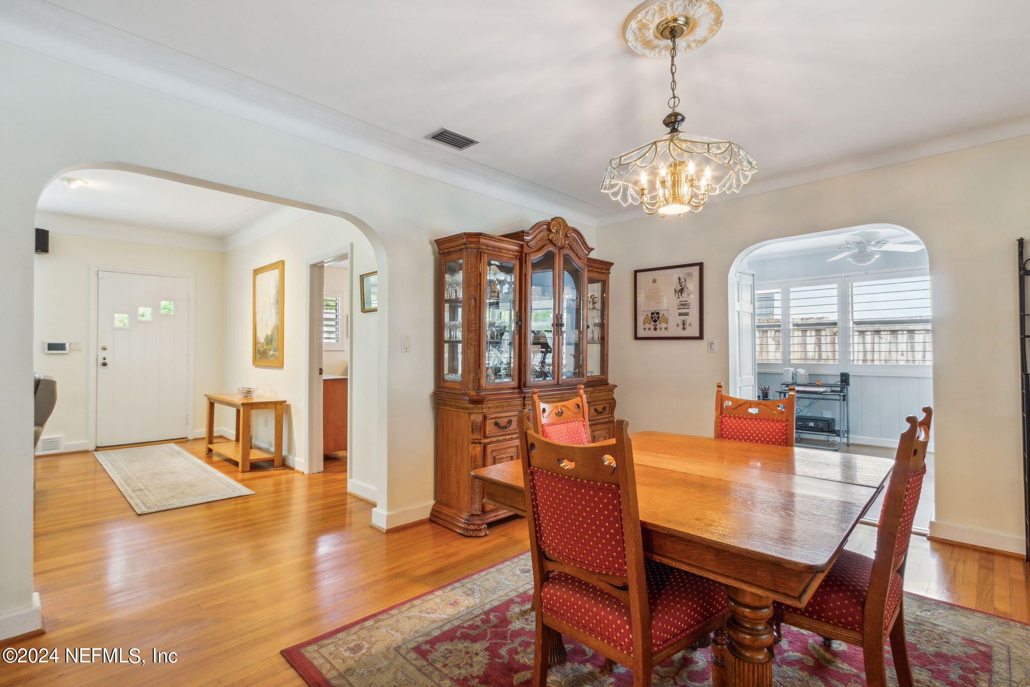 1605 Brookwood Road Jacksonville, FL 32207 - Photo 12 of 40 a view of a dining room with furniture a chandelier and wooden floor