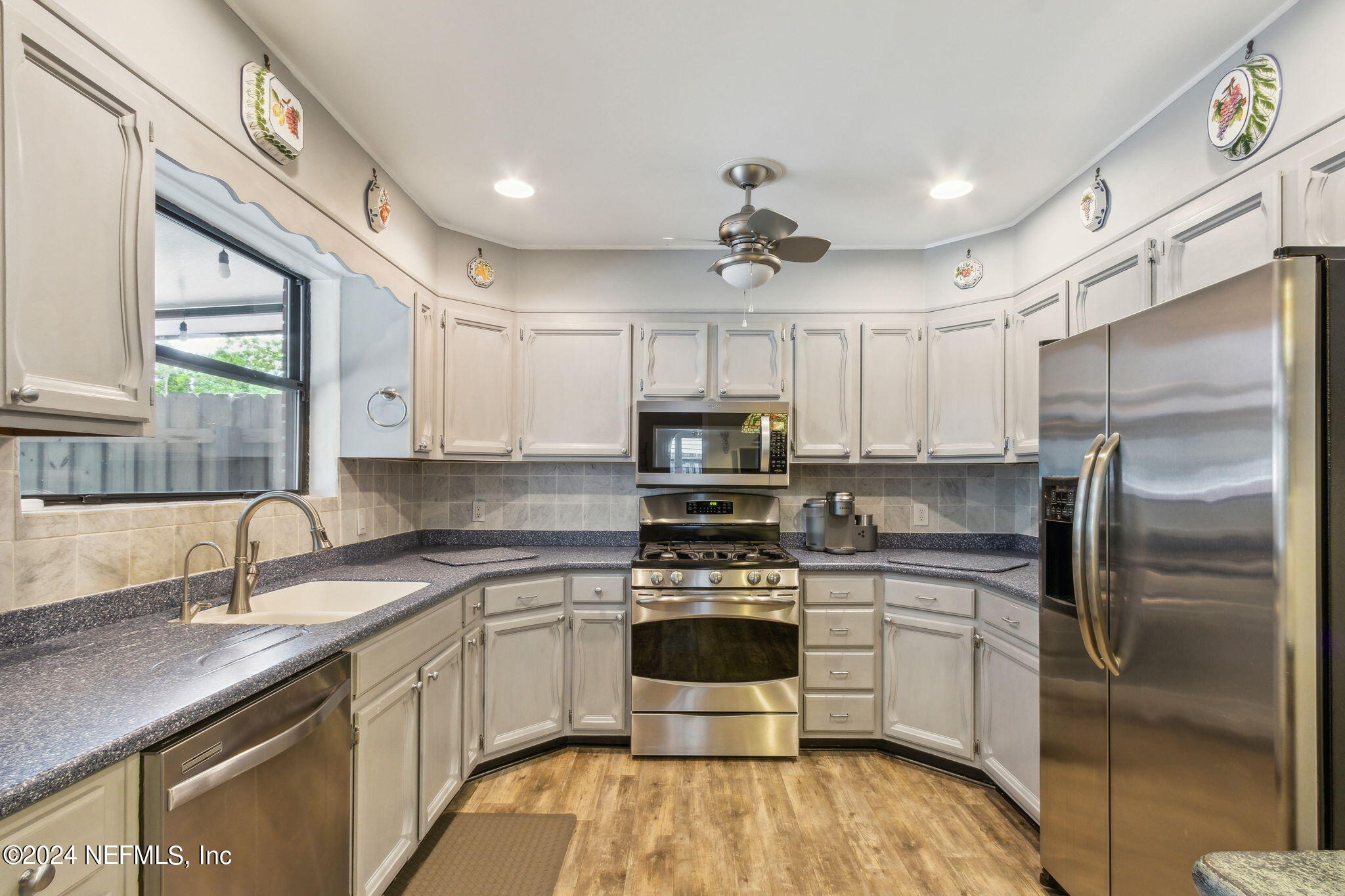 1605 Brookwood Road Jacksonville, FL 32207 - Photo 13 of 40 a kitchen with stainless steel appliances a refrigerator sink and cabinets