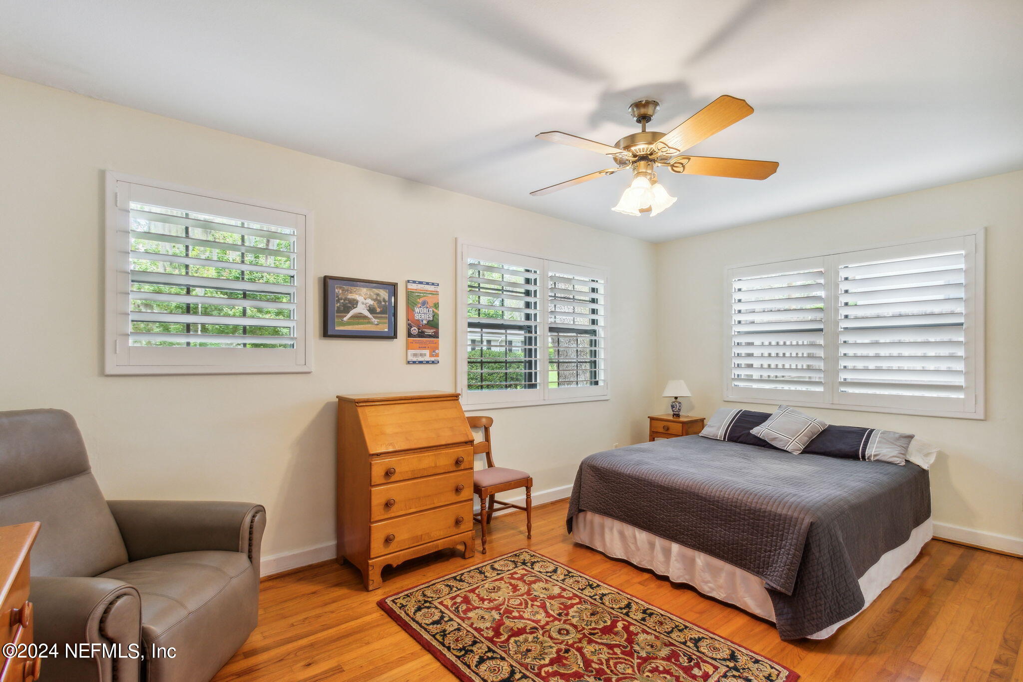 1605 Brookwood Road Jacksonville, FL 32207 - Photo 17 of 40 a bedroom with a bed and wooden floor