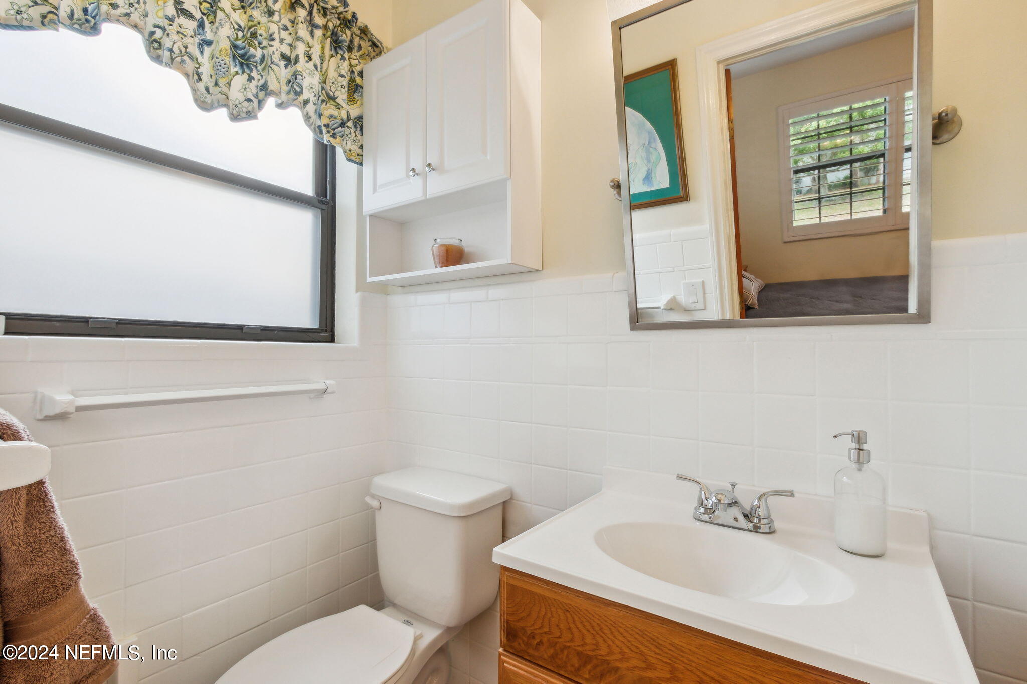 1605 Brookwood Road Jacksonville, FL 32207 - Photo 19 of 40 a bathroom with a sink mirror and toilet
