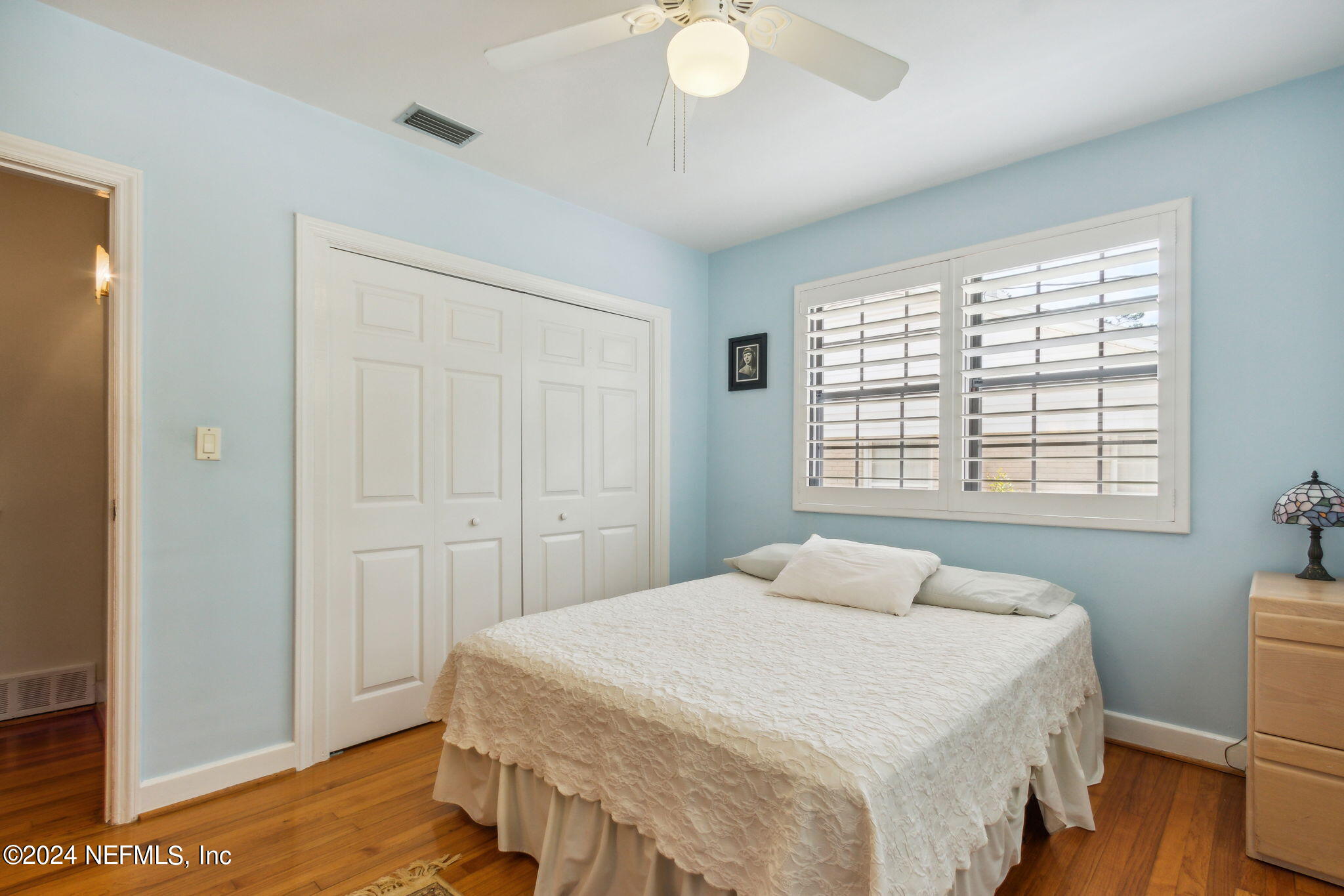 1605 Brookwood Road Jacksonville, FL 32207 - Photo 22 of 40 a bedroom with a bed and a chandelier
