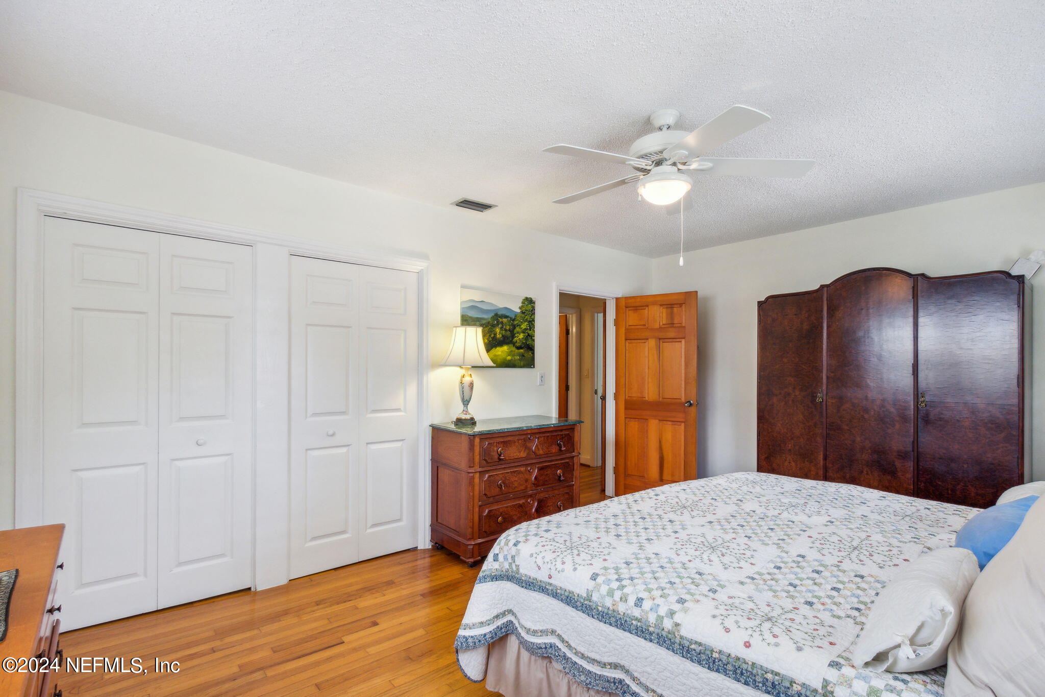 1605 Brookwood Road Jacksonville, FL 32207 - Photo 24 of 40 a bedroom with a bed and a dresser with wooden floor