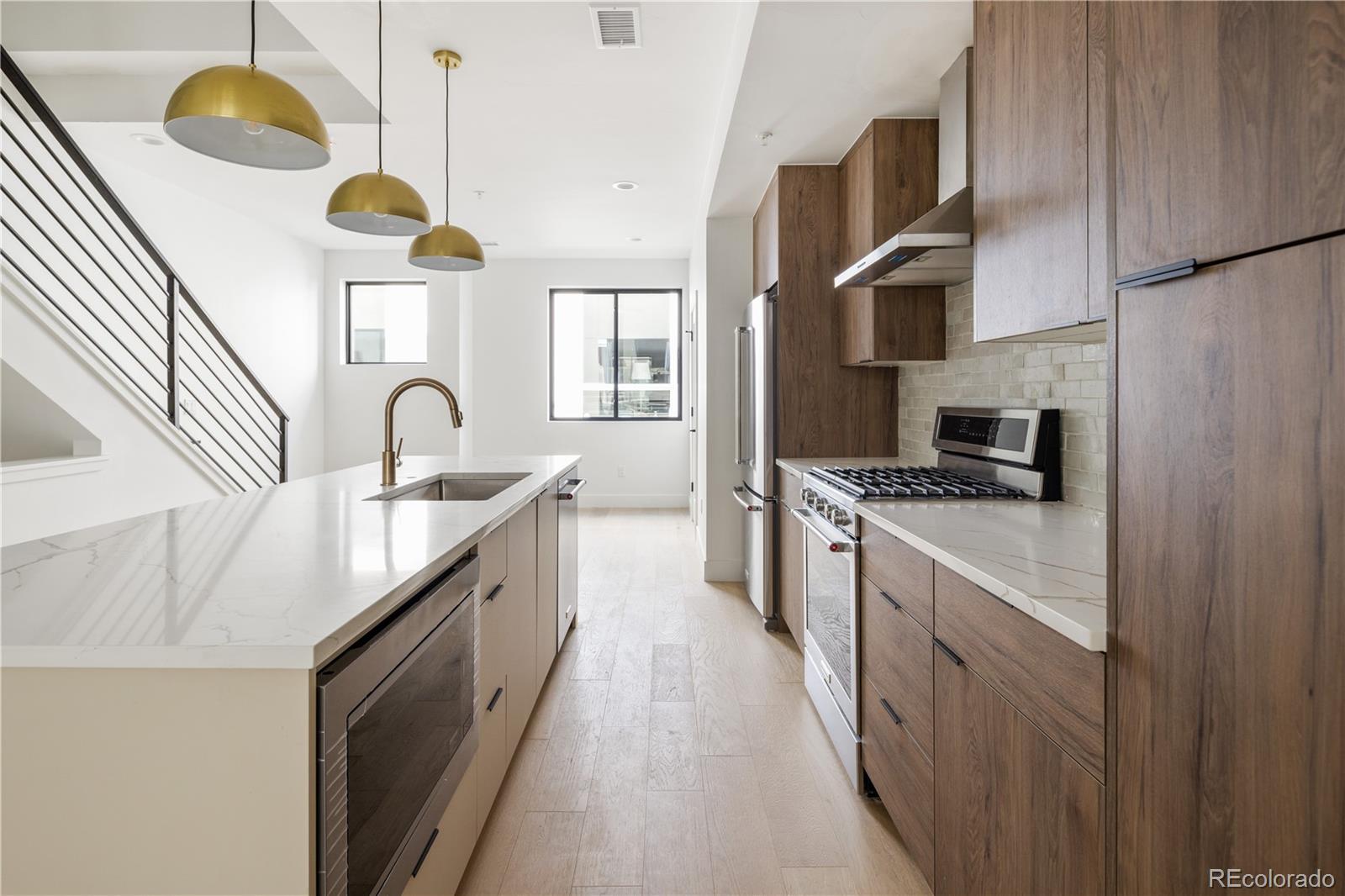 4517 Tennyson Street Denver, CO 80212 - Photo 11 of 34 a kitchen with stainless steel appliances granite countertop a sink a stove and a refrigerator