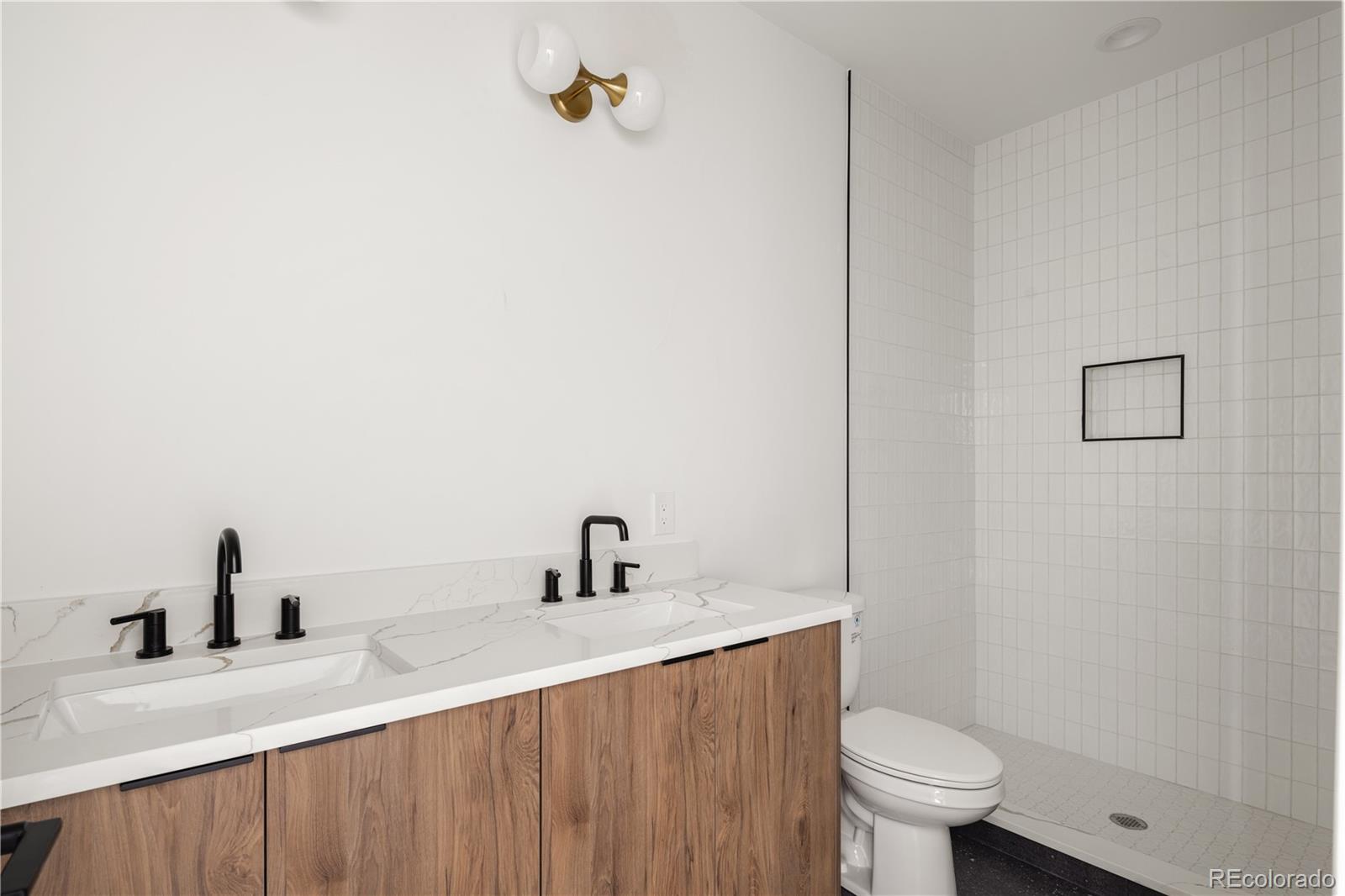 4517 Tennyson Street Denver, CO 80212 - Photo 24 of 34 a bathroom with a sink a toilet and a mirror