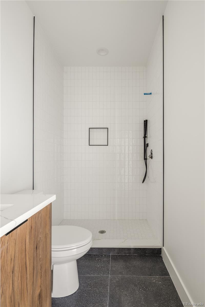 4517 Tennyson Street Denver, CO 80212 - Photo 26 of 34 a bathroom with a toilet and shower