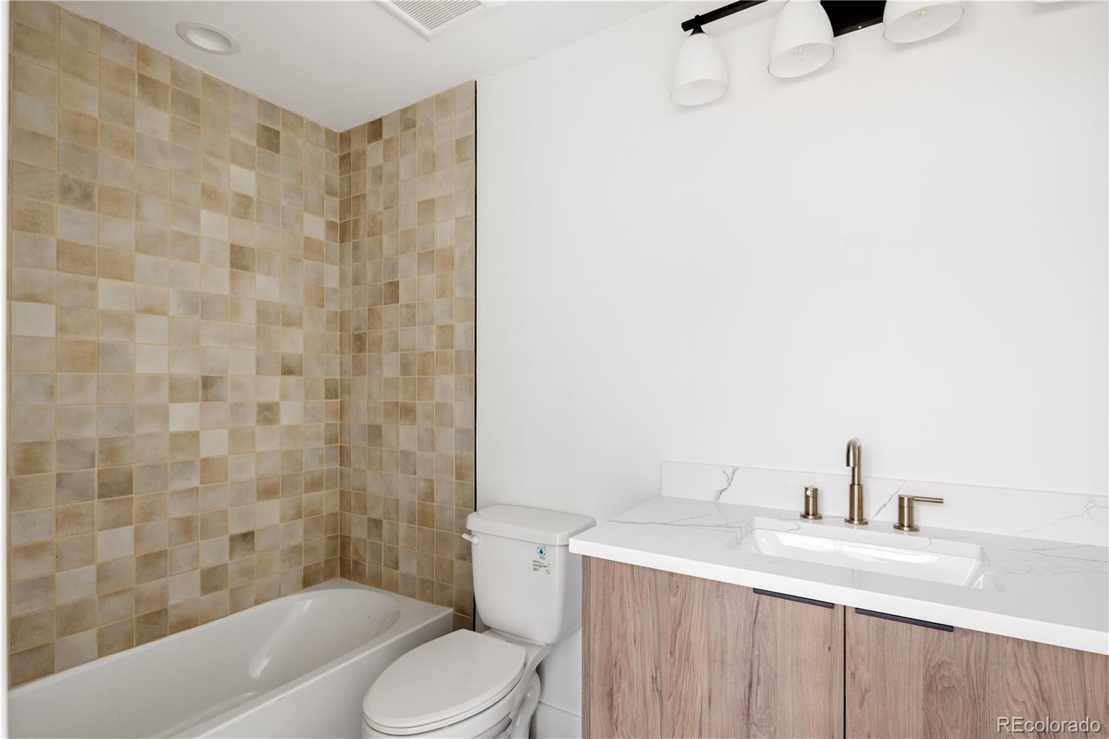 4517 Tennyson Street Denver, CO 80212 - Photo 3 of 34 a bathroom with a sink toilet and shower