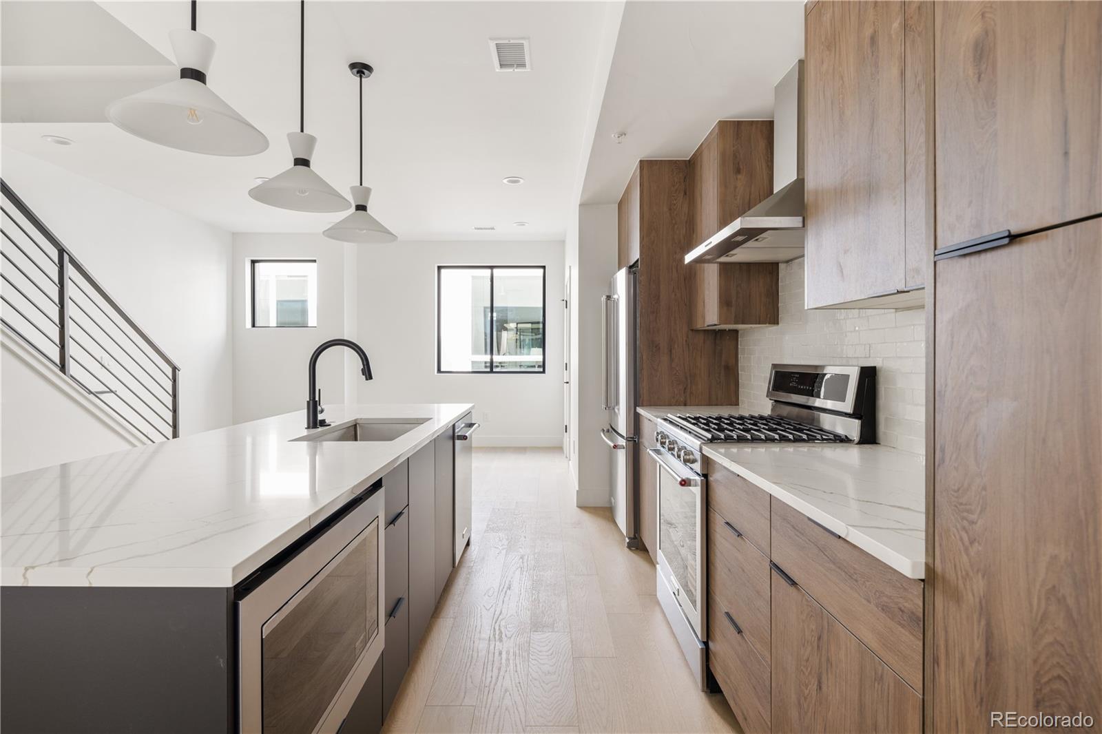 4517 Tennyson Street Denver, CO 80212 - Photo 31 of 34 a kitchen with stainless steel appliances granite countertop a sink stove and refrigerator