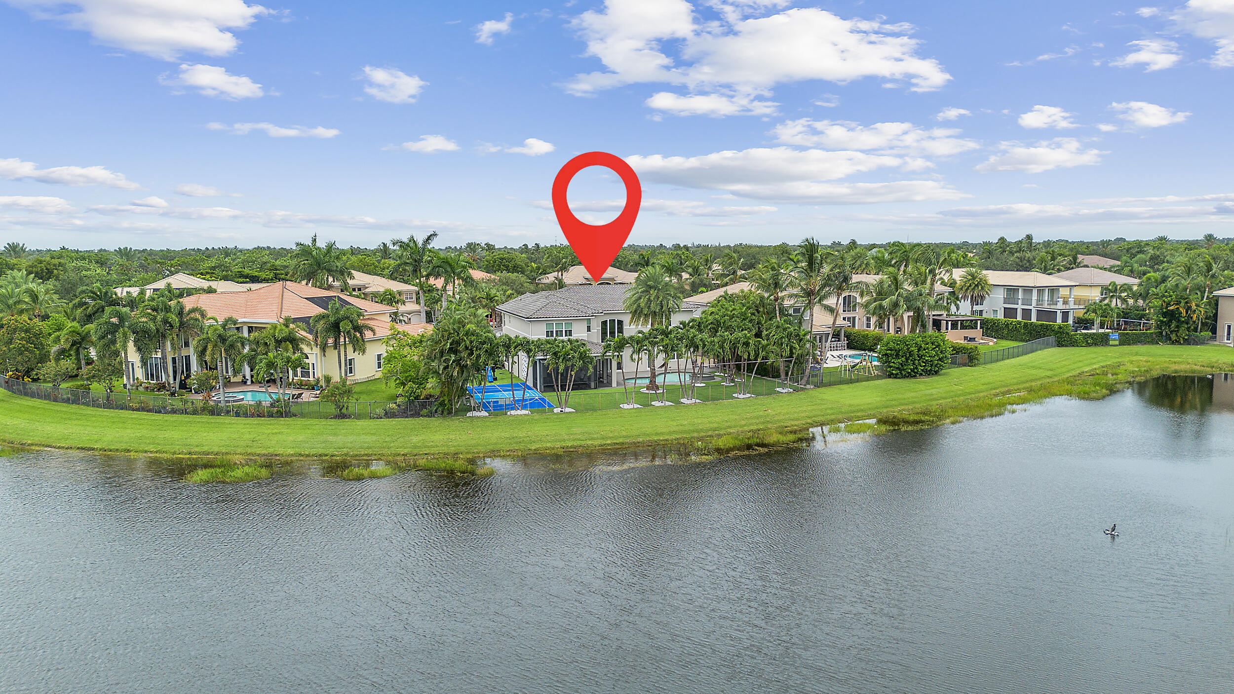 8680 Daystar Ridge Point Boynton Beach, FL 33473 - Photo 22 of 25 a view of a lake with a house in the background