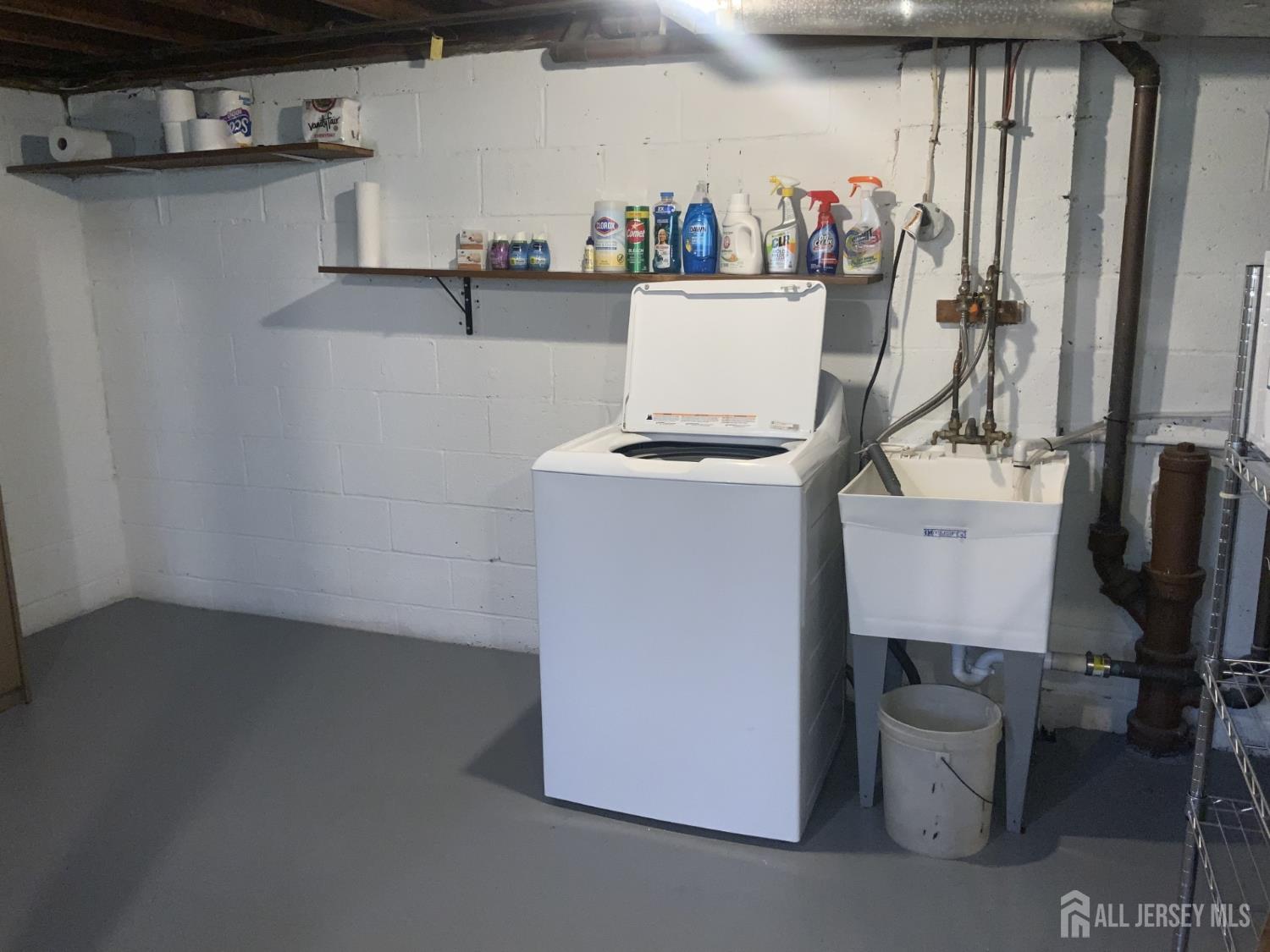 178 Willow Street Port Reading, NJ 07064 - Photo 14 of 15 a room with water heater and wooden cabinets