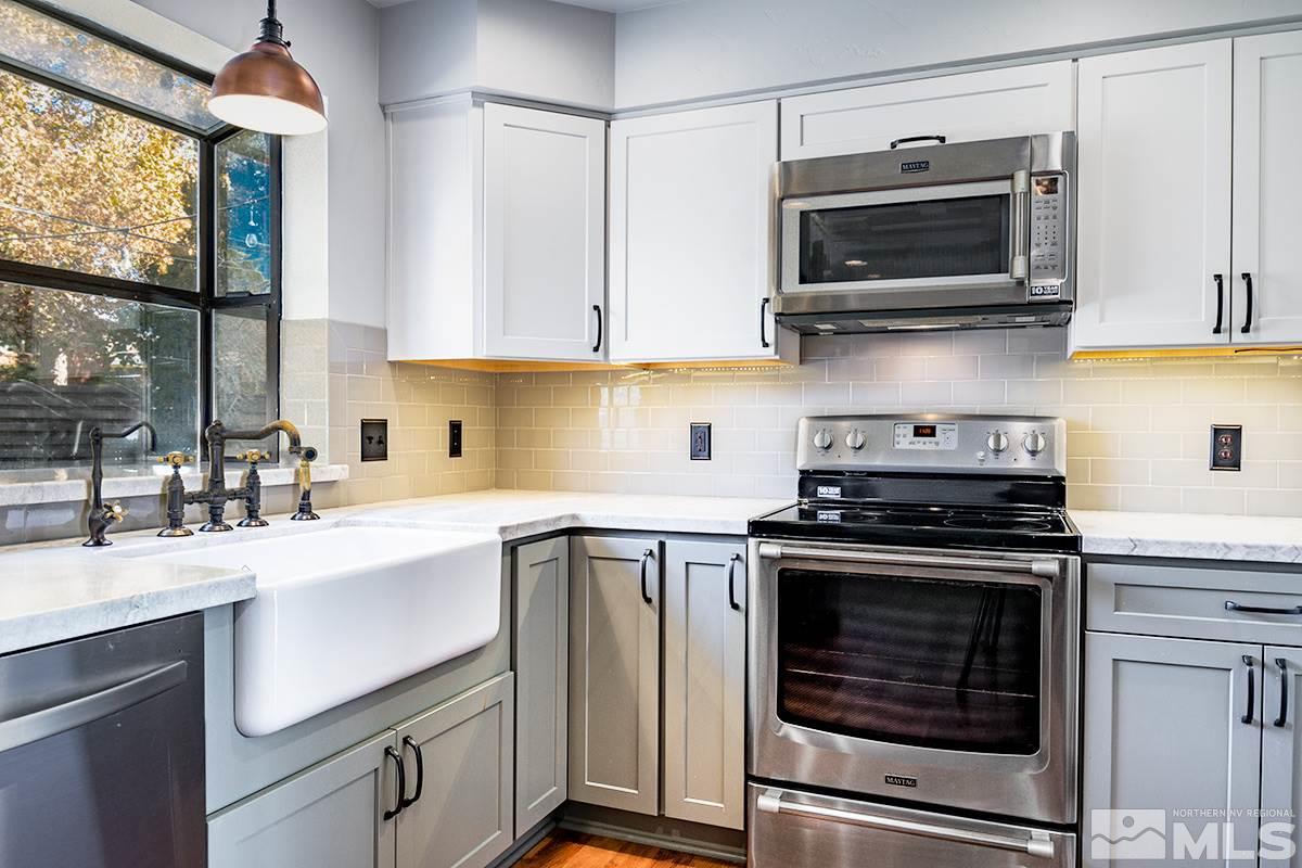 845 West 11th Street Reno, NV 89503 - Photo 13 of 23 a kitchen with cabinets stainless steel appliances a sink and a stove