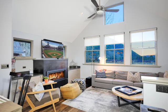 a living room with fireplace furniture and a flat screen tv