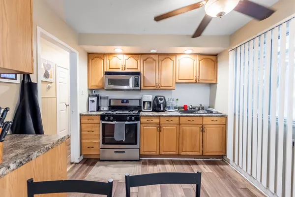 a kitchen with stainless steel appliances granite countertop a stove a sink and a refrigerator