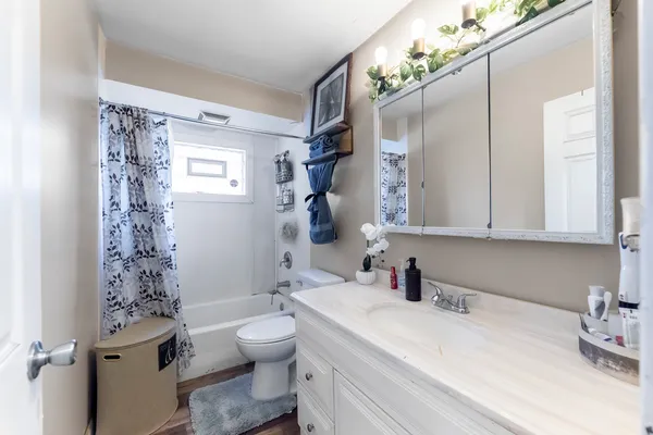 a bathroom with a sink toilet tub and shower