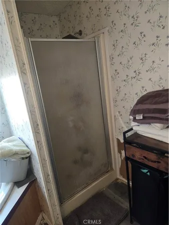 a bathroom with a toilet a sink and a mirror