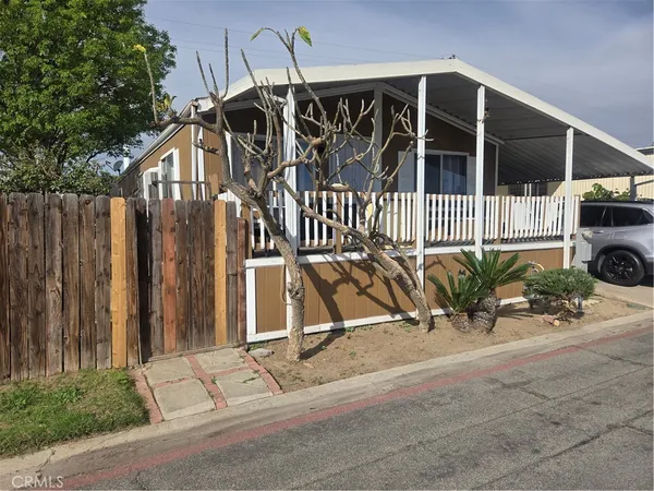 a view of a house with a bench in patio