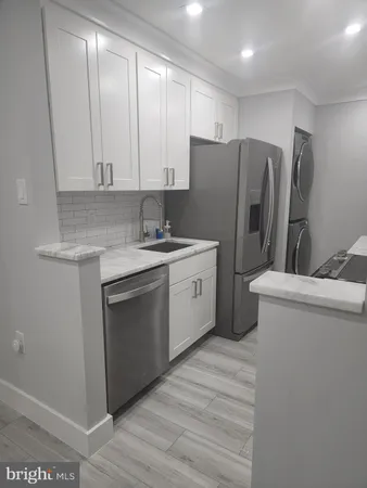 a kitchen with a refrigerator sink and cabinets
