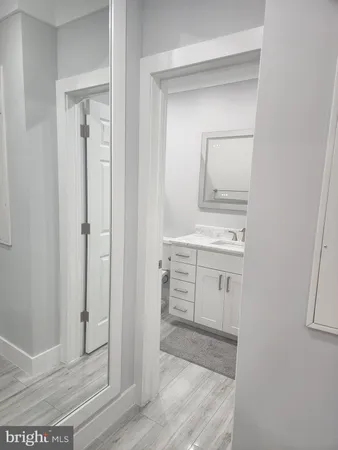 a bathroom with a shower sink and mirror