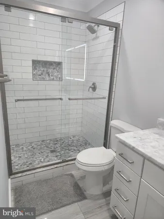 a bathroom with a toilet and shower