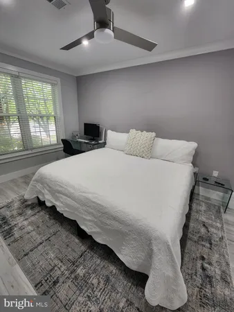 a bedroom with a bed and a large window