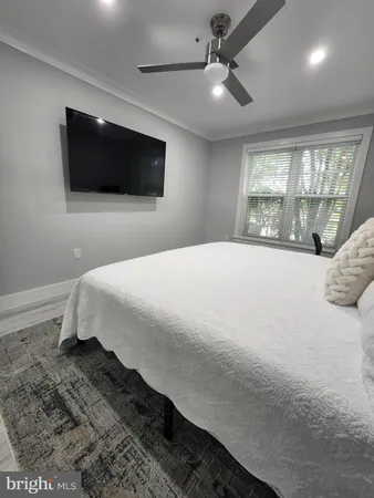 a bedroom with a large bed and a flat screen tv