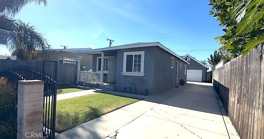 a backyard of a house with yard and outdoor seating