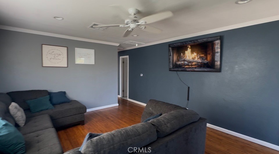 22211 Joliet Avenue Hawaiian Gardens, CA 90716 - Photo 4 of 14 a living room with furniture and a ceiling fan