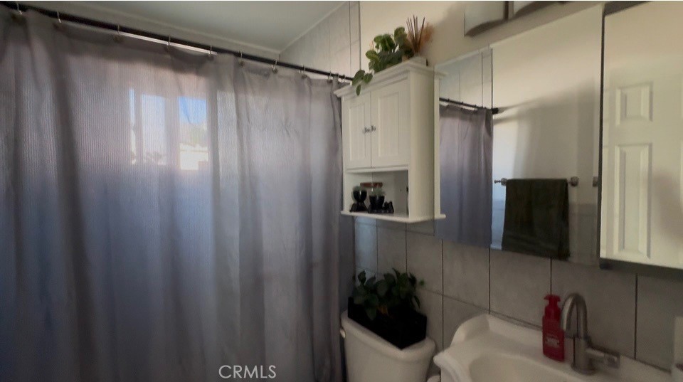 22211 Joliet Avenue Hawaiian Gardens, CA 90716 - Photo 6 of 14 a bathroom with a sink and a mirror