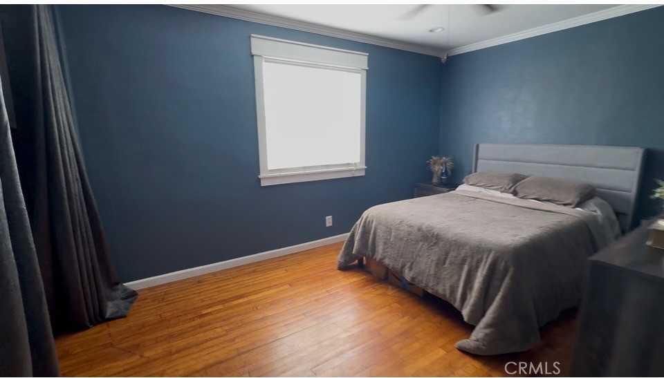 22211 Joliet Avenue Hawaiian Gardens, CA 90716 - Photo 7 of 14 a bedroom with a bed and a window