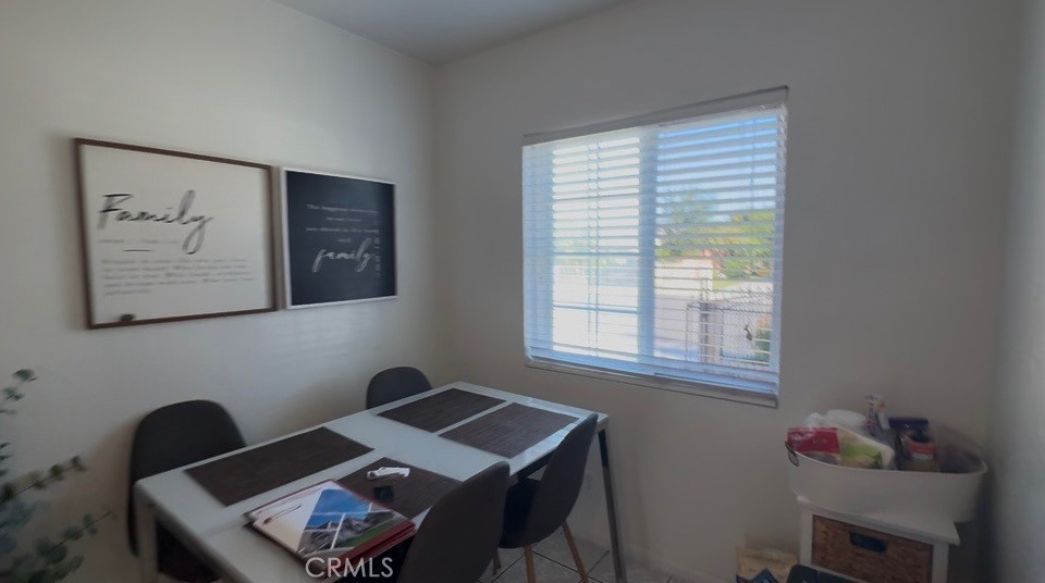22211 Joliet Avenue Hawaiian Gardens, CA 90716 - Photo 8 of 14 a room that has a table and a chair in it