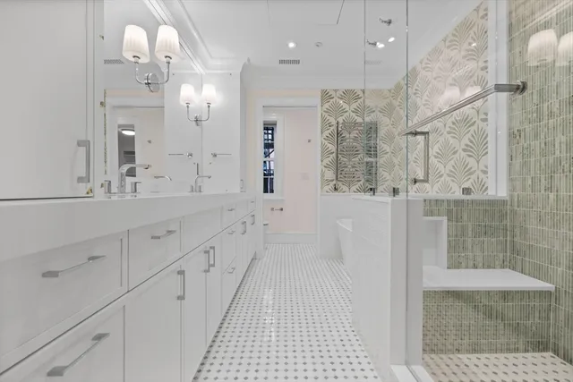 a bathroom with a double vanity sink mirror and shower