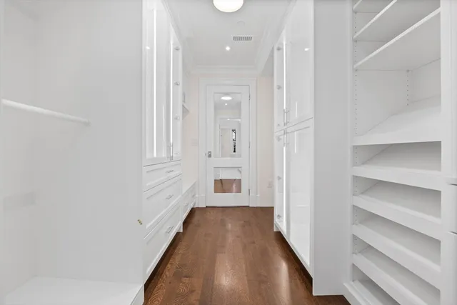 a view of a hallway with wooden floor and entryway