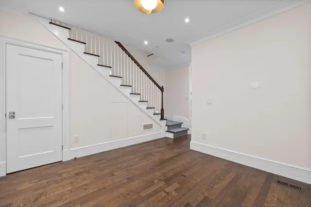 a view of entryway with stairs and wooden floor