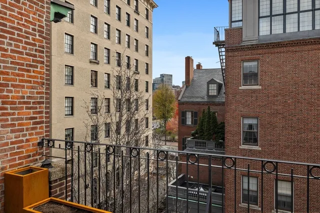 a view of a brick building next to a yard