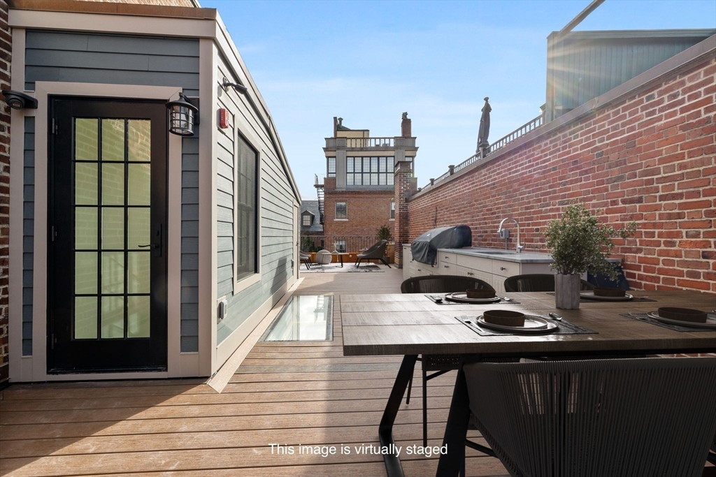 2 Byron Street Boston, MA 02108 - Photo 30 of 30 a view of a balcony with chairs and wooden floor
