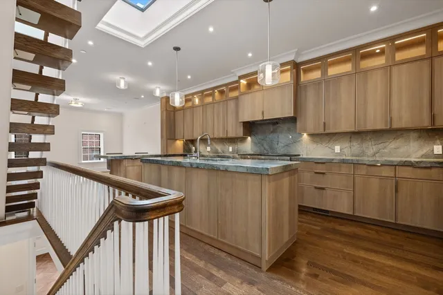 a kitchen with sink a microwave and cabinets