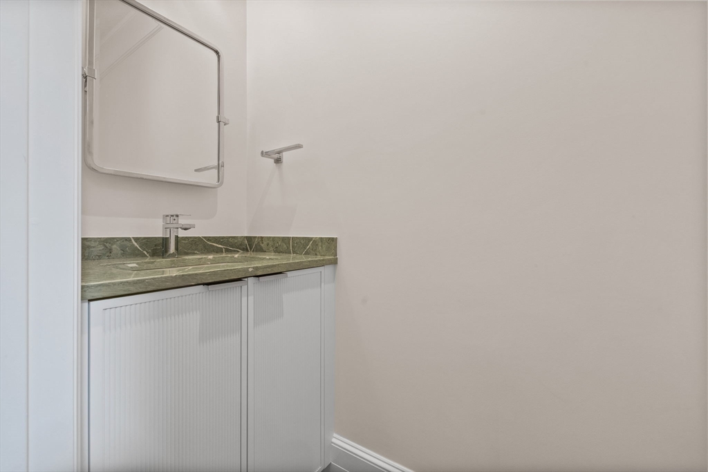 2 Byron Street Boston, MA 02108 - Photo 8 of 30 a bathroom with a granite countertop sink and a mirror