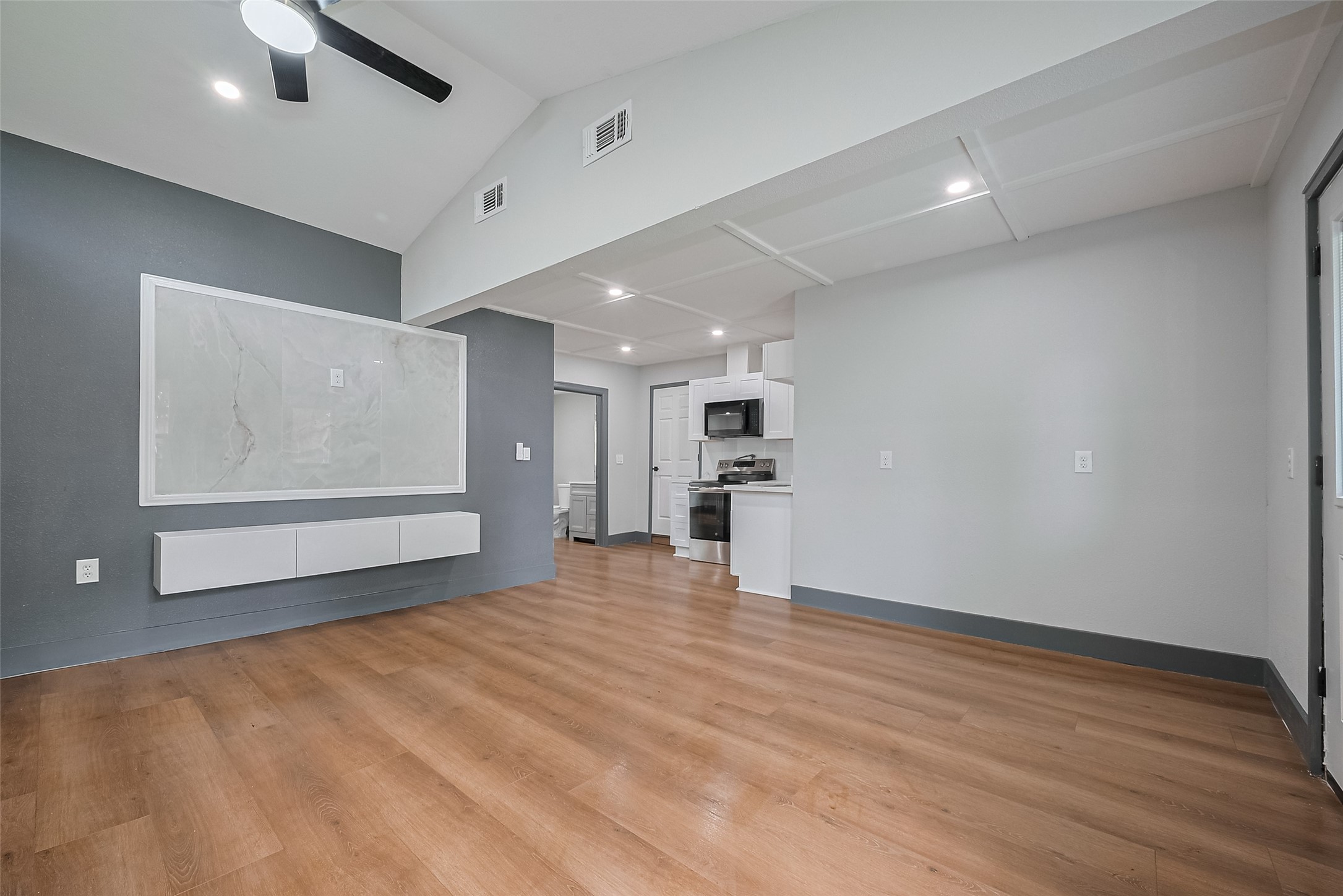 6058 Lyndhurst Drive Houston, TX 77033 - Photo 11 of 50 a view of an empty room with wooden floor and a window