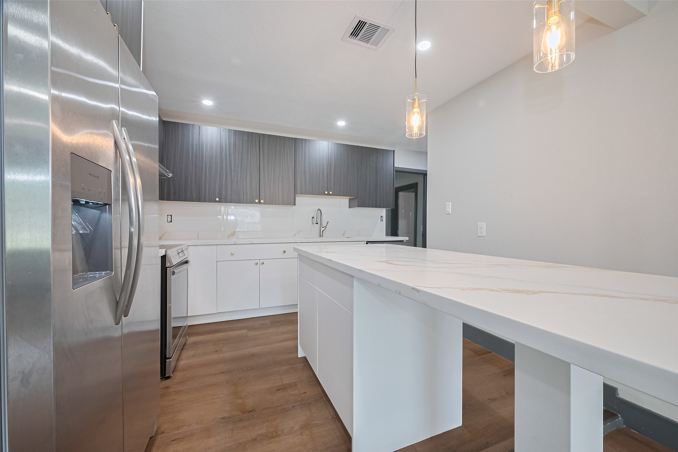 6058 Lyndhurst Drive Houston, TX 77033 - Photo 14 of 50 a kitchen with white cabinets and refrigerator