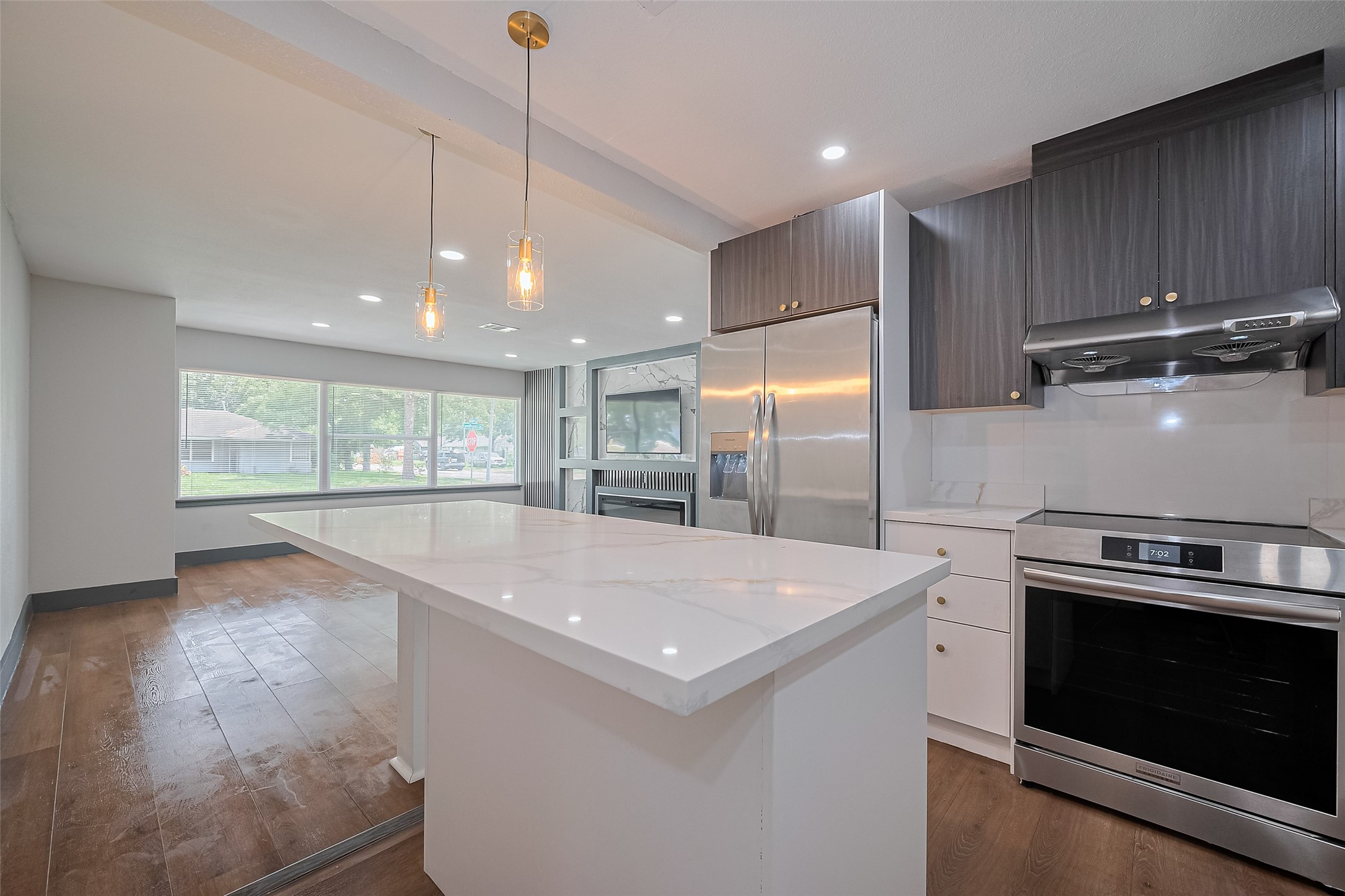 6058 Lyndhurst Drive Houston, TX 77033 - Photo 18 of 50 a view of a kitchen with a stove wooden cabinets and a window
