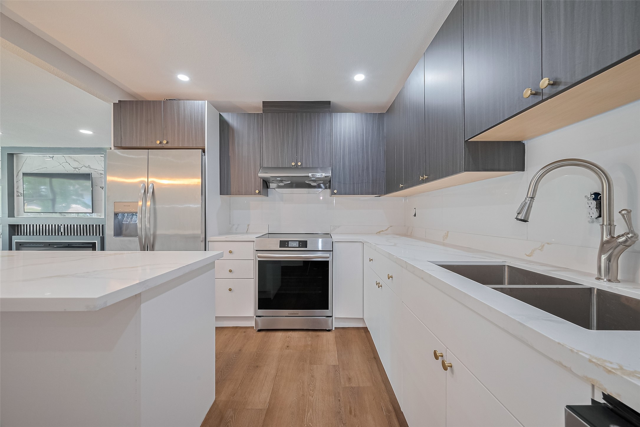 6058 Lyndhurst Drive Houston, TX 77033 - Photo 19 of 50 a large kitchen with stainless steel appliances a sink a stove and a refrigerator