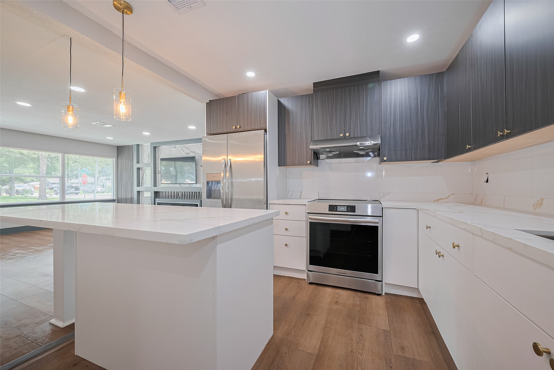 6058 Lyndhurst Drive Houston, TX 77033 - Photo 20 of 50 a large kitchen with stainless steel appliances granite countertop a stove a sink and a refrigerator