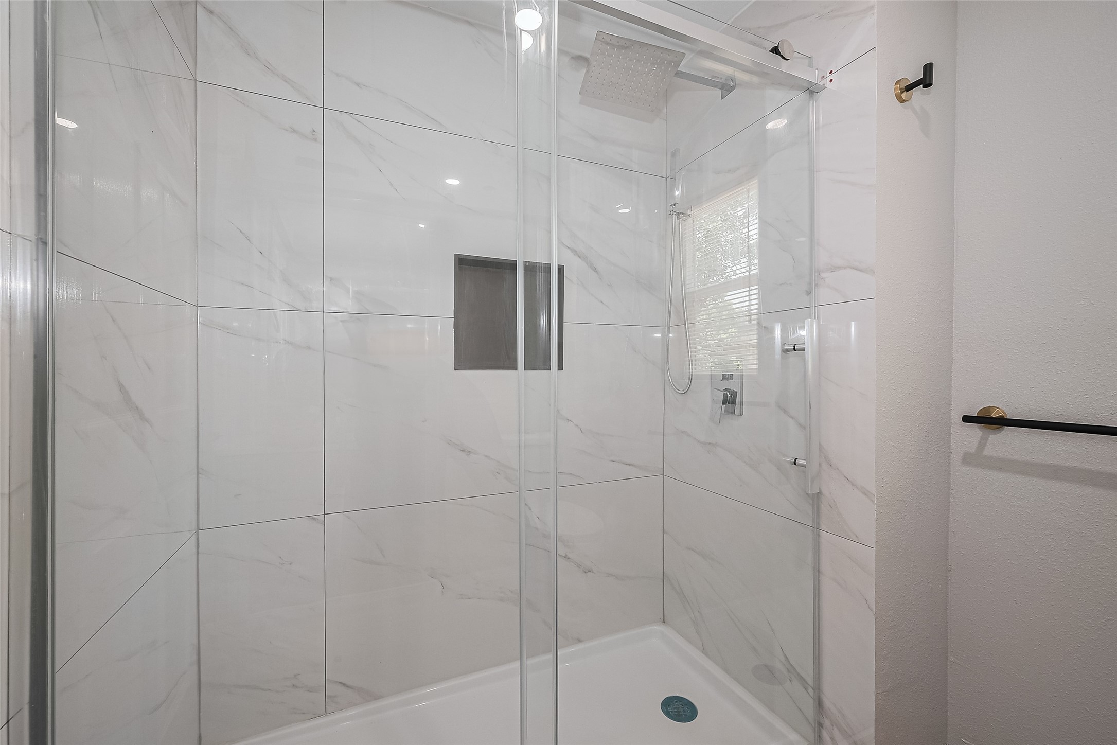 6058 Lyndhurst Drive Houston, TX 77033 - Photo 27 of 50 a bathroom with a shower and a glass door