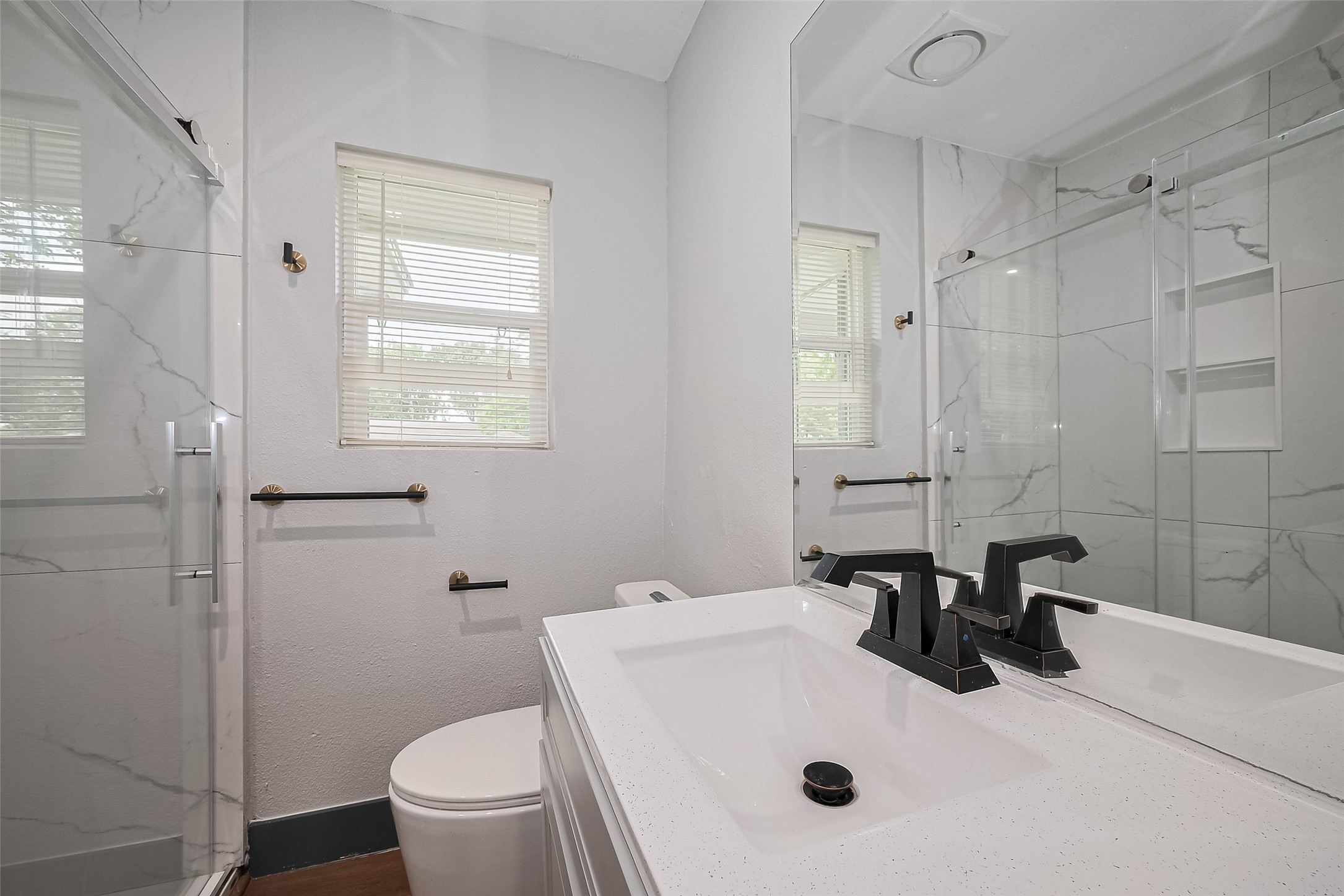 6058 Lyndhurst Drive Houston, TX 77033 - Photo 34 of 50 a bathroom with a sink toilet and shower