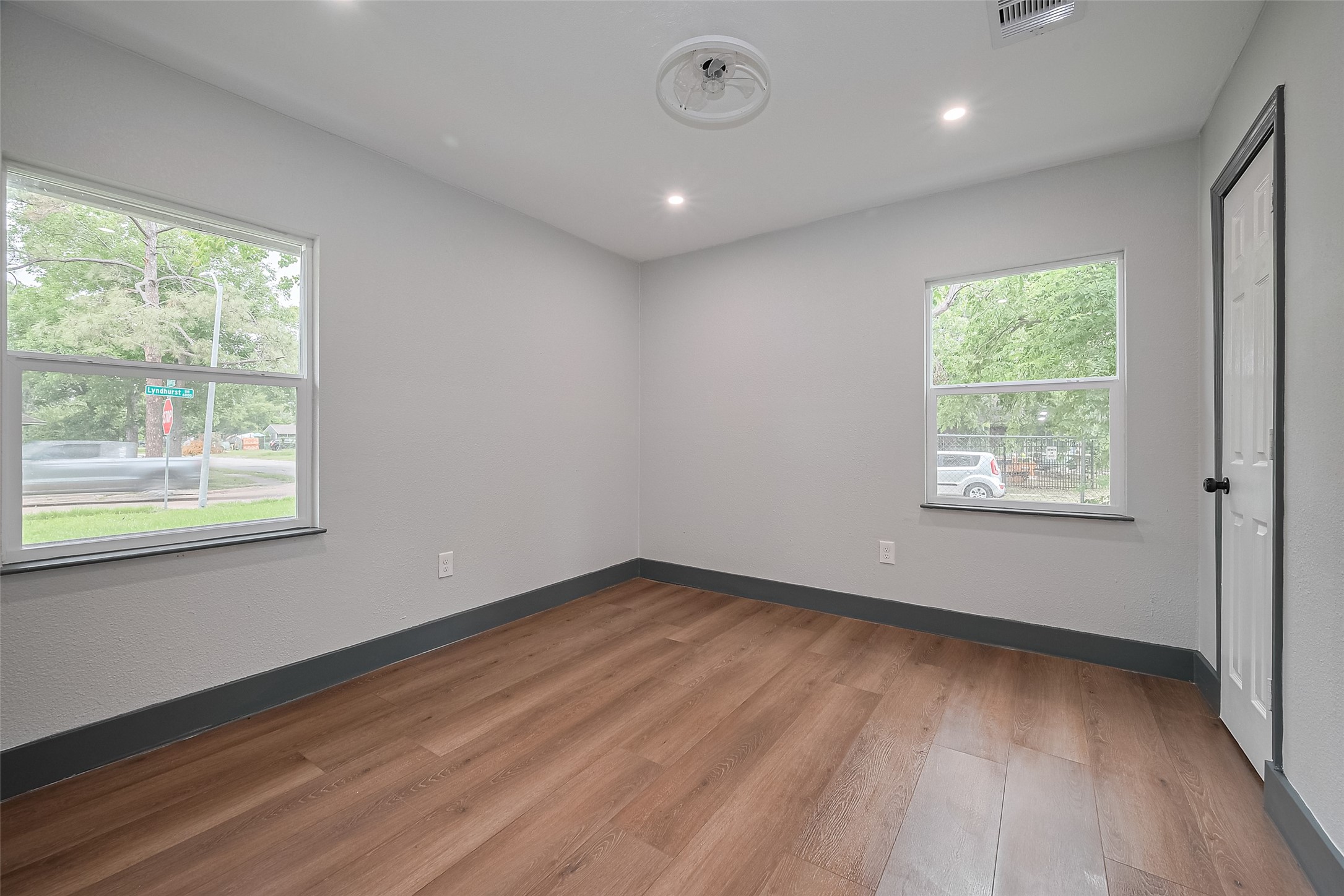 6058 Lyndhurst Drive Houston, TX 77033 - Photo 37 of 50 a view of an empty room with wooden floor and a window
