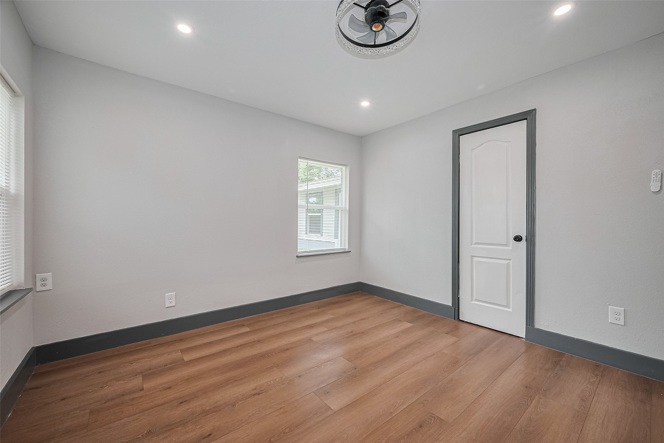 6058 Lyndhurst Drive Houston, TX 77033 - Photo 39 of 50 an empty room with a window and wooden floor