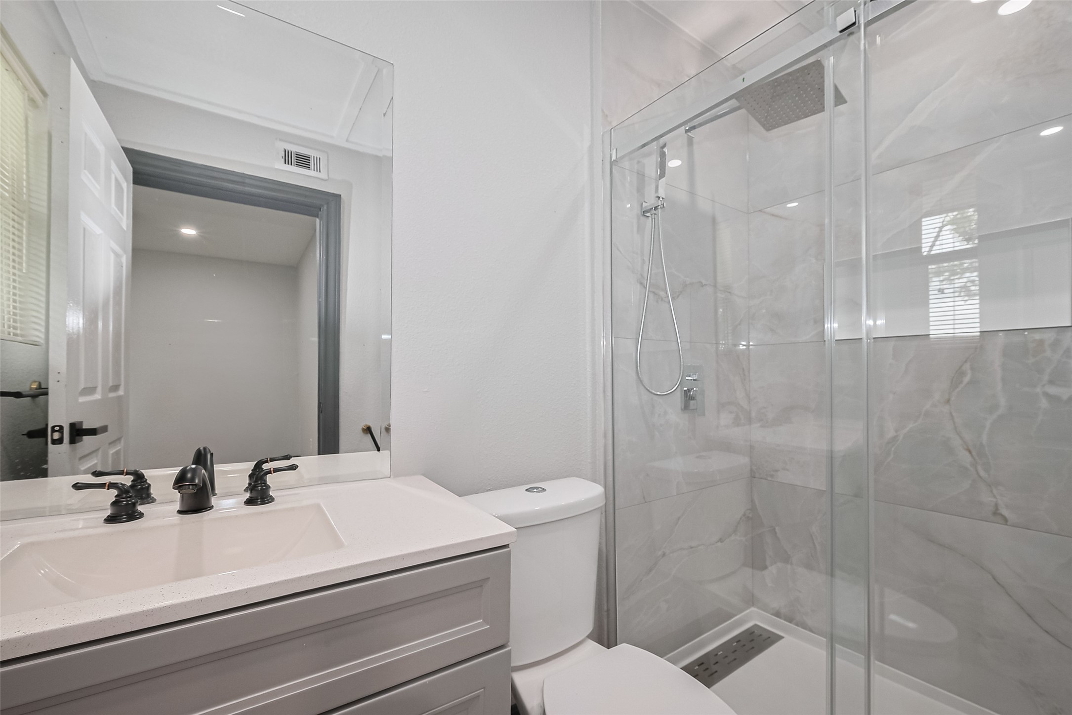 6058 Lyndhurst Drive Houston, TX 77033 - Photo 47 of 50 a bathroom with a sink a toilet and shower