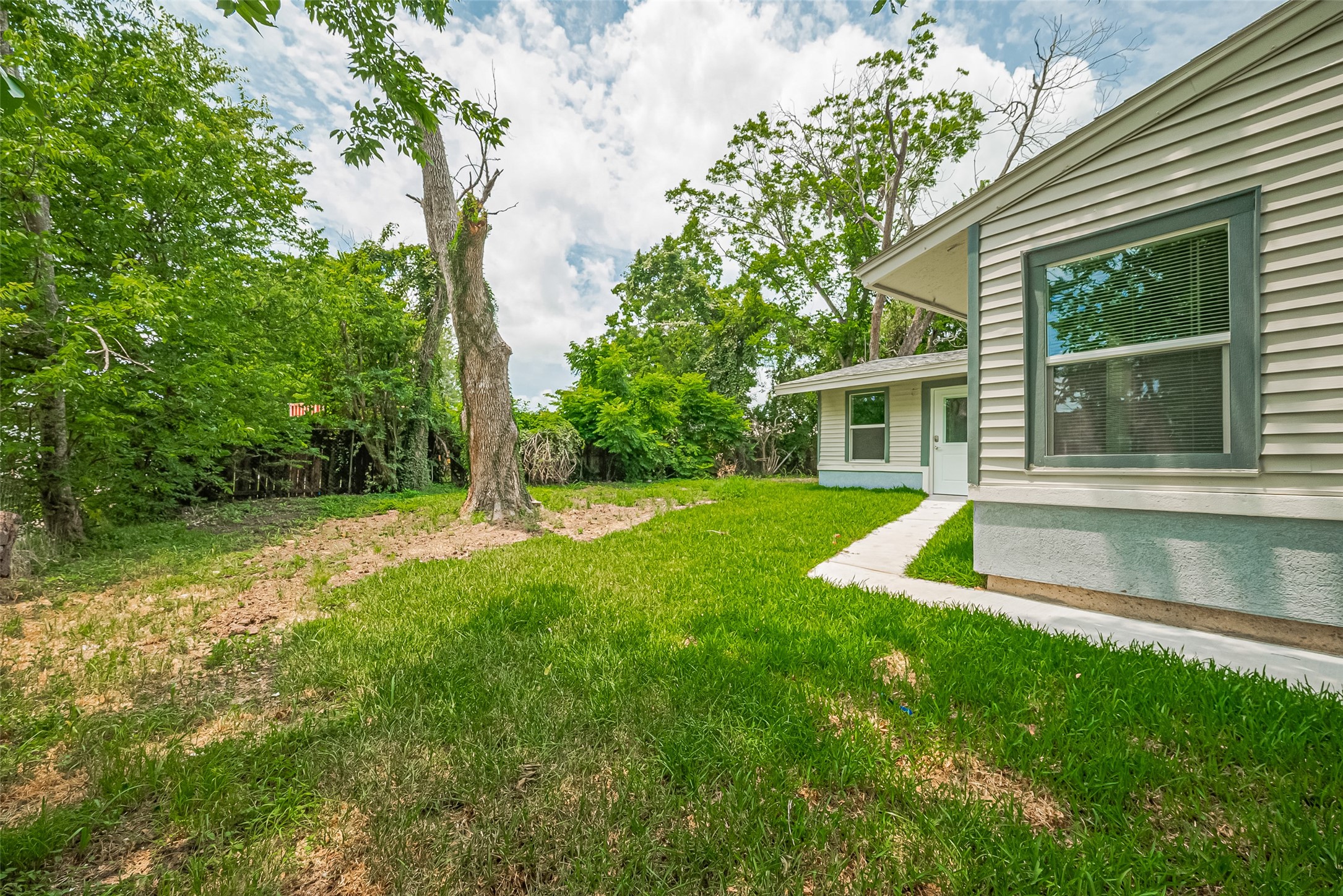 6058 Lyndhurst Drive Houston, TX 77033 - Photo 48 of 50 a view of a house with a yard patio and a tree