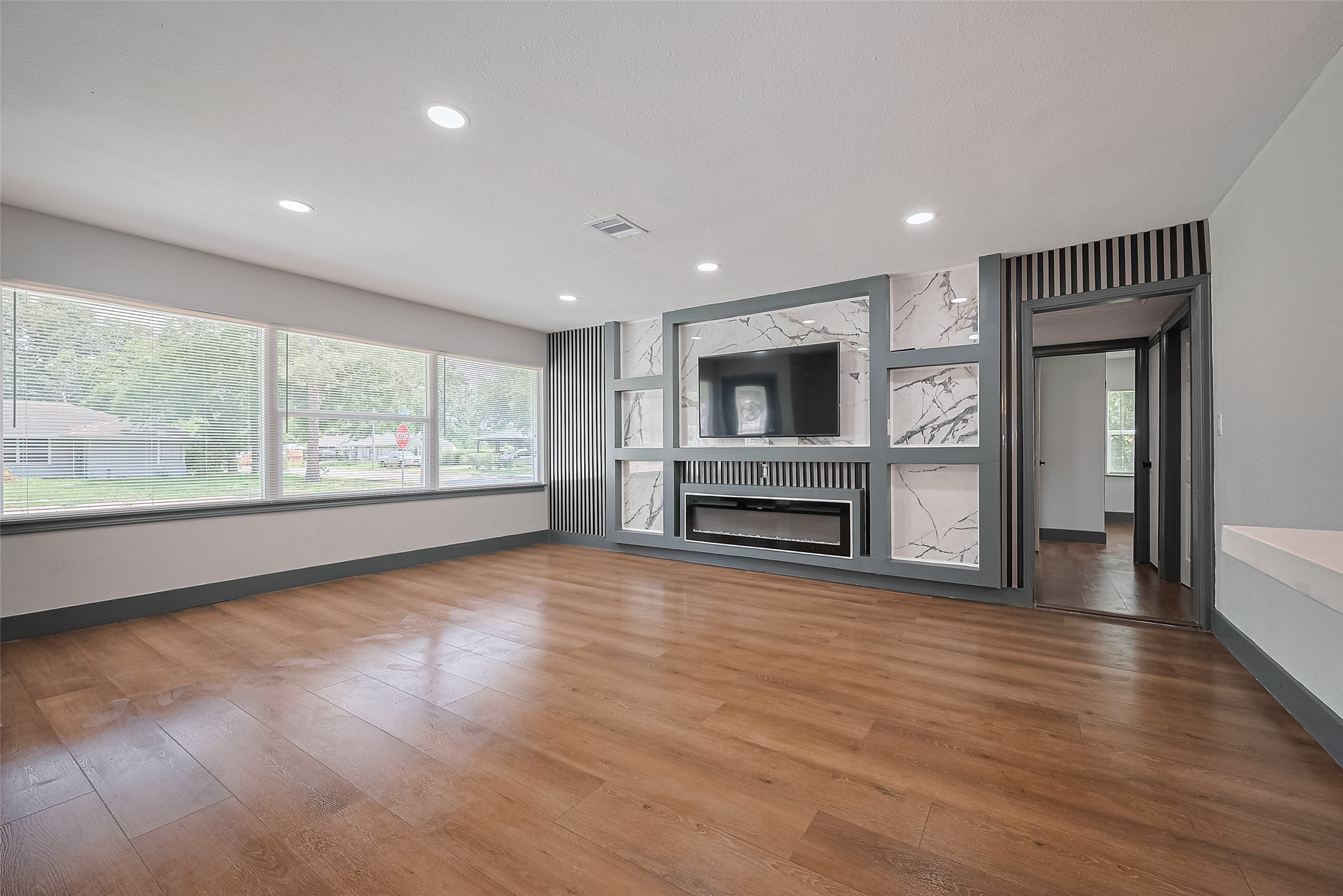 6058 Lyndhurst Drive Houston, TX 77033 - Photo 7 of 50 a view of empty room with wooden floor and fireplace